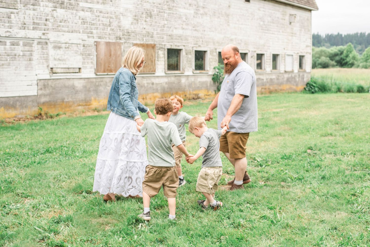 A series of candid family photos showing tender moments and embraces in an outdoor setting with natural lighting.