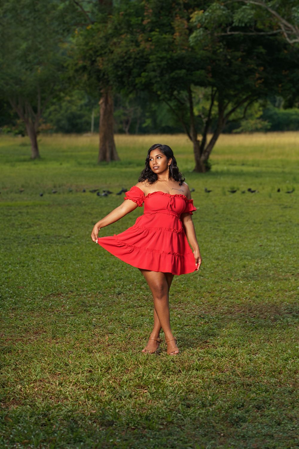 A sequence of dance poses in a red dress against a green outdoor backdrop shows graceful movement and expression.