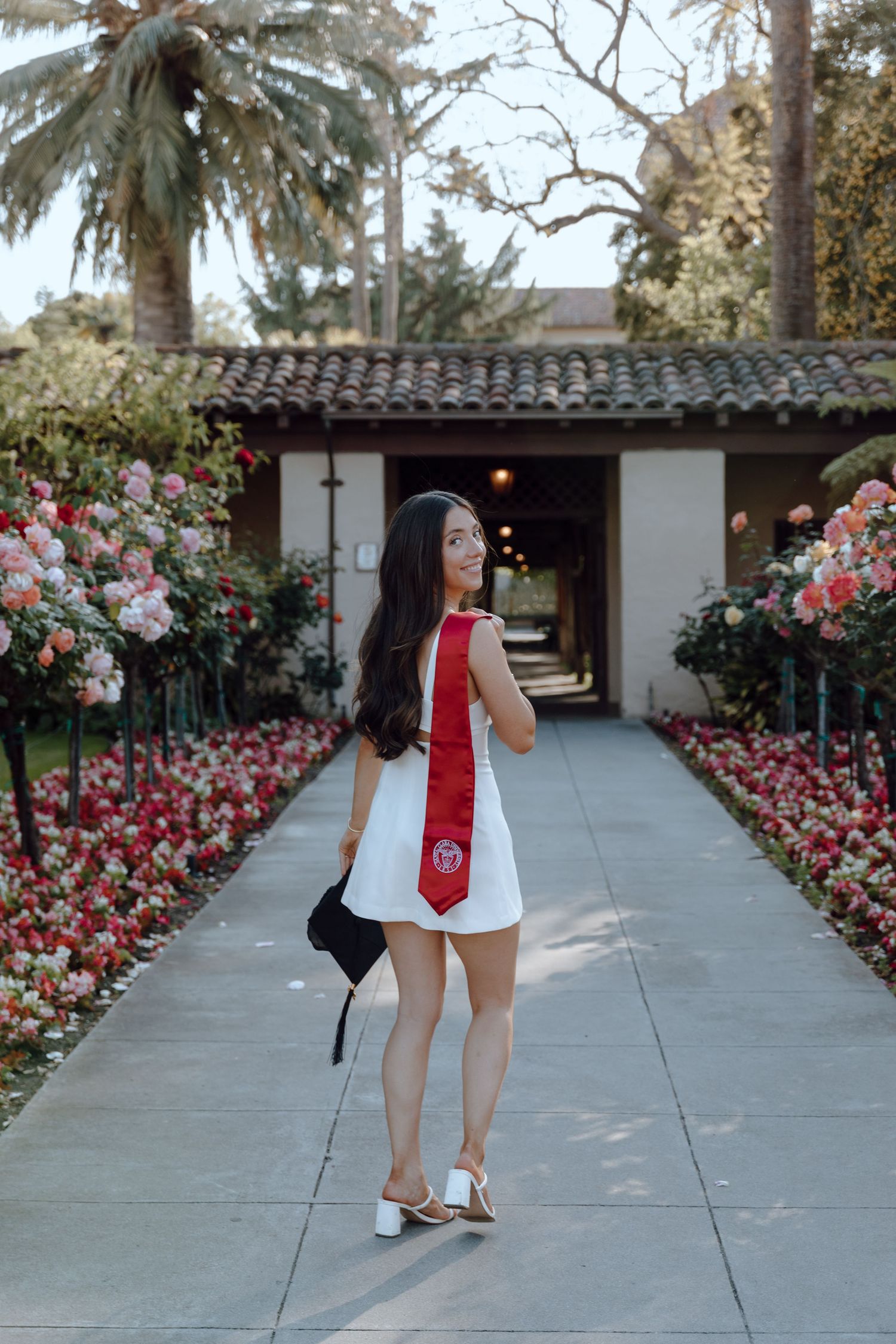 Solo grad portrait of a college senior taking her photos at the Bay Area's Santa Clara University.
