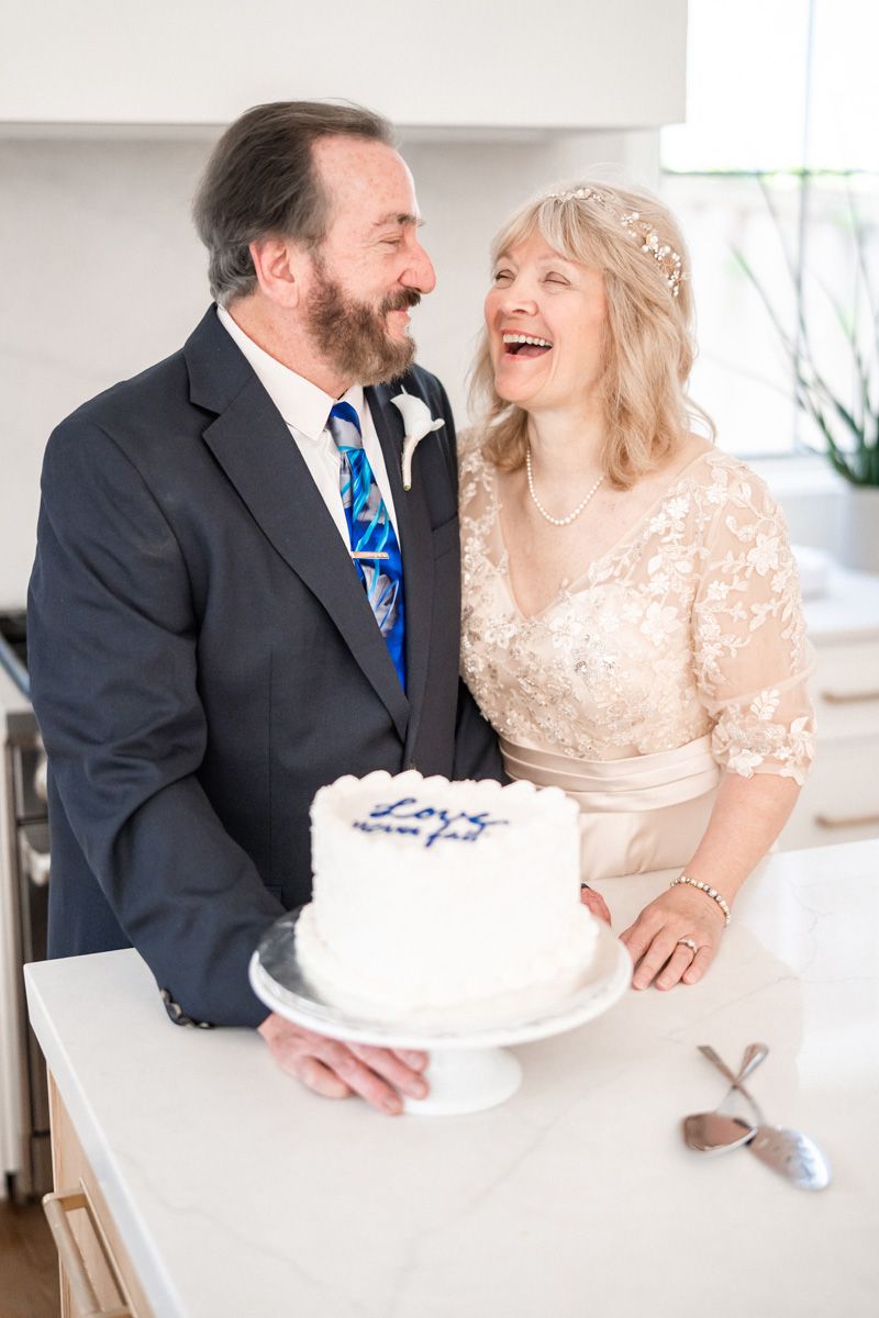 Candid photo of wedding couple with their cake.