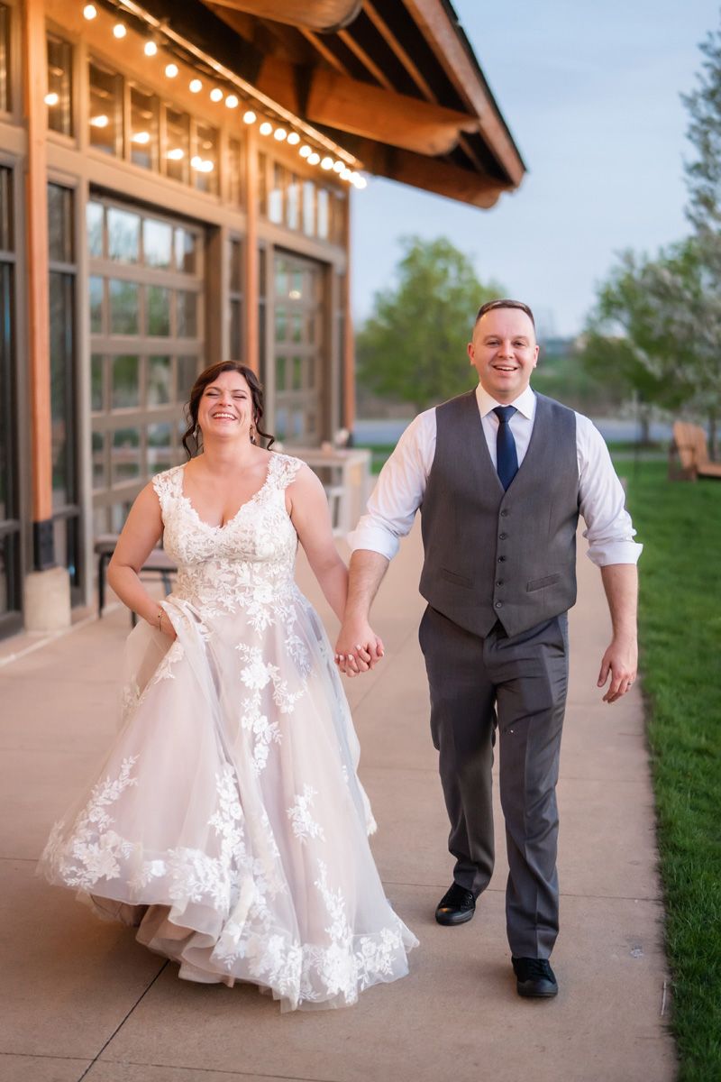 Bride and groom laughing during their reception at Pinstripes wedding venue in Northbrook, Illinois.