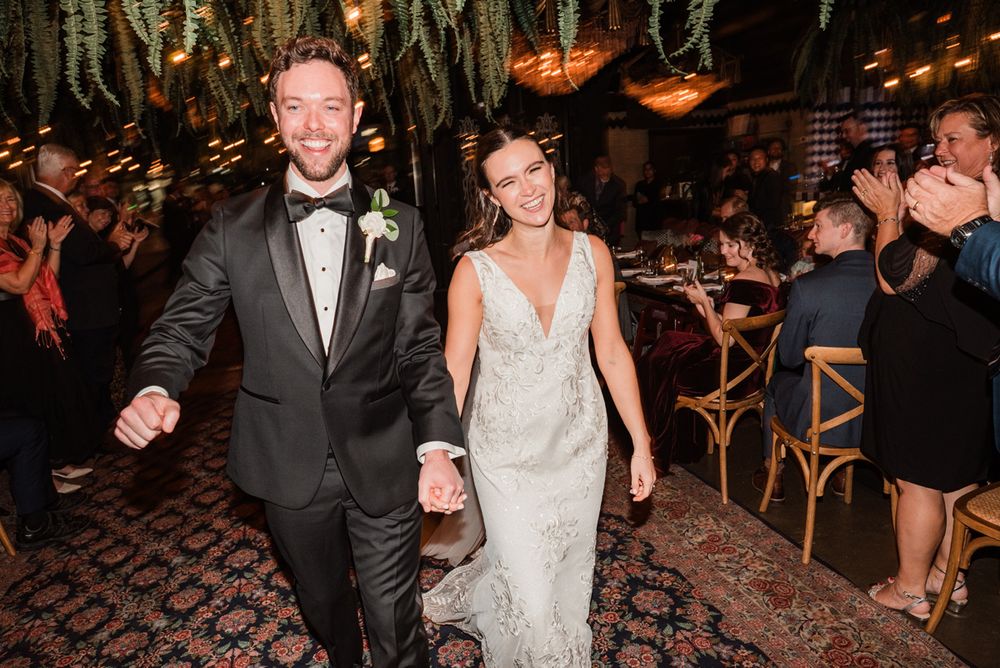 Wedding couple laughing and celebrating as they walk back down the aisle at their wedding ceremony in Beatnik West Town in Chicago.