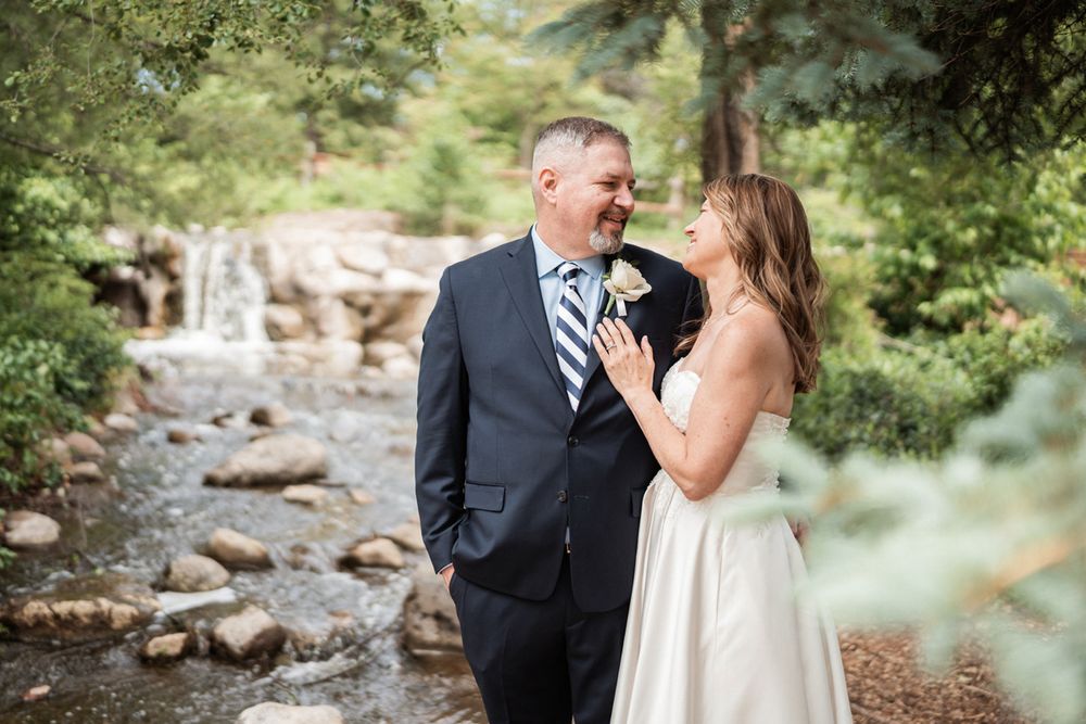 Portrait of bride and groom with waterfall at Lake Katherine in Palos, Illinois.