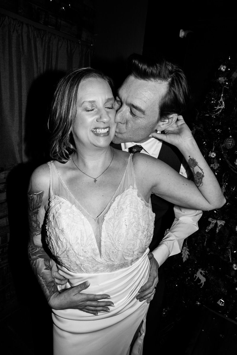 Romantic portrait of bride and groom kissing at reception at Maize and Mash Restaurant in Glen Ellyn, Illinois.