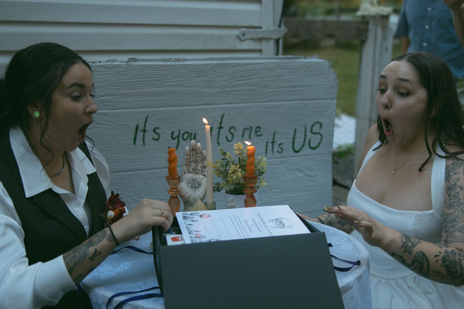 lgbtq lesbian couple surprised all inclusive elopement gift box at wedding in asheville nc