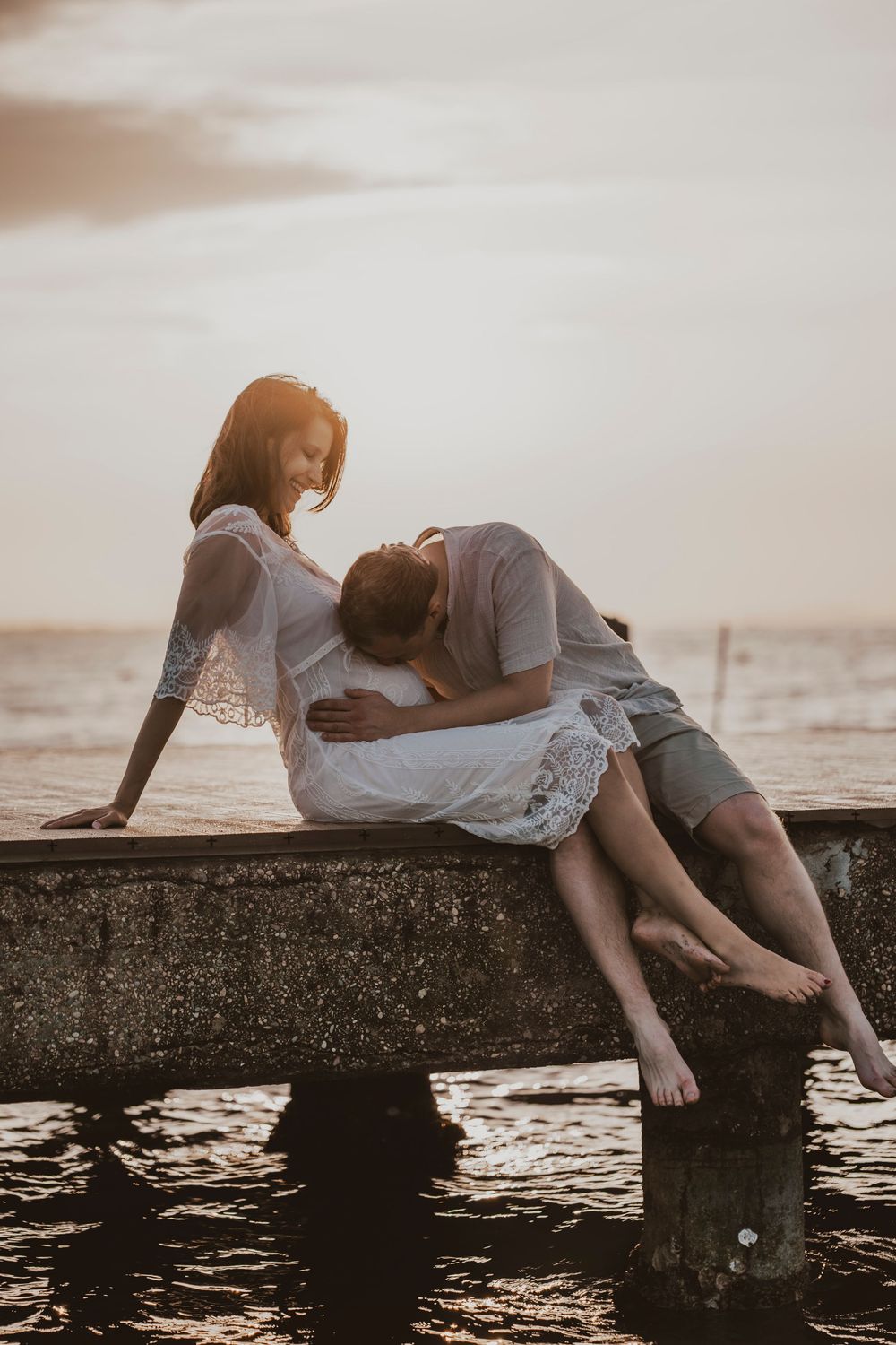 Destination wedding photographer capturing a candid laugh between an engaged couple on Caorle beach.