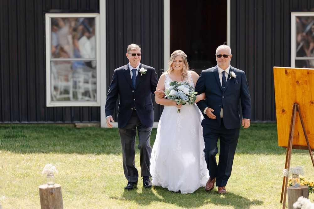 A series of wedding photos showing a couple and their guests celebrating on a sunny day by a dark barn.