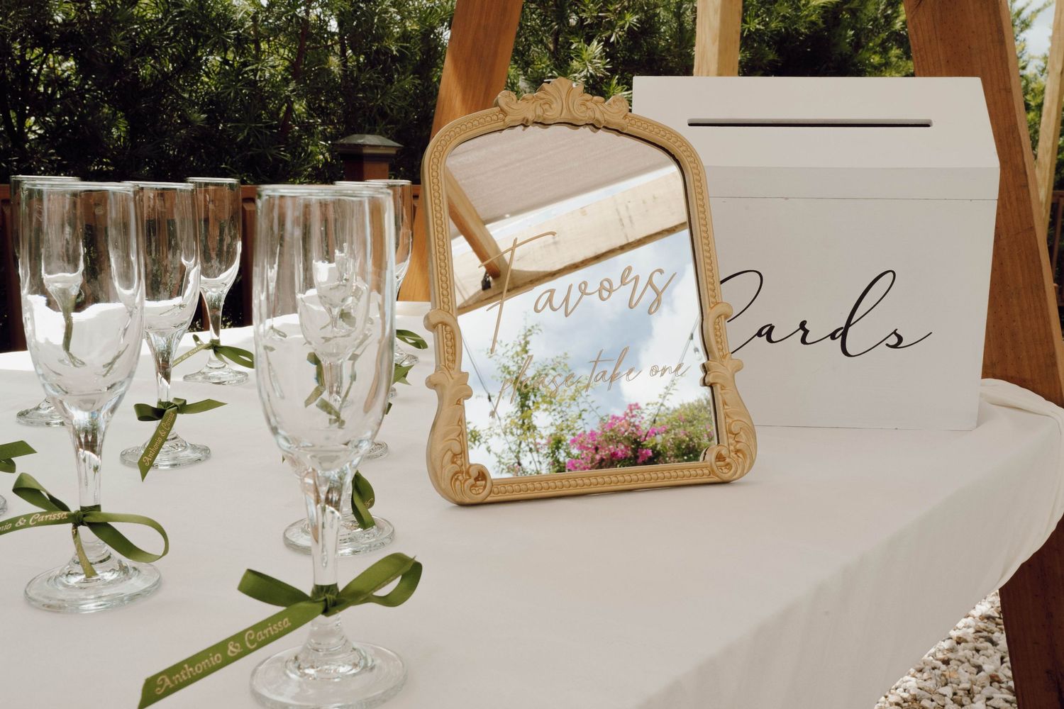 Elegant table settings with white linens, wine glasses, and decorative name cards for a formal dining event.