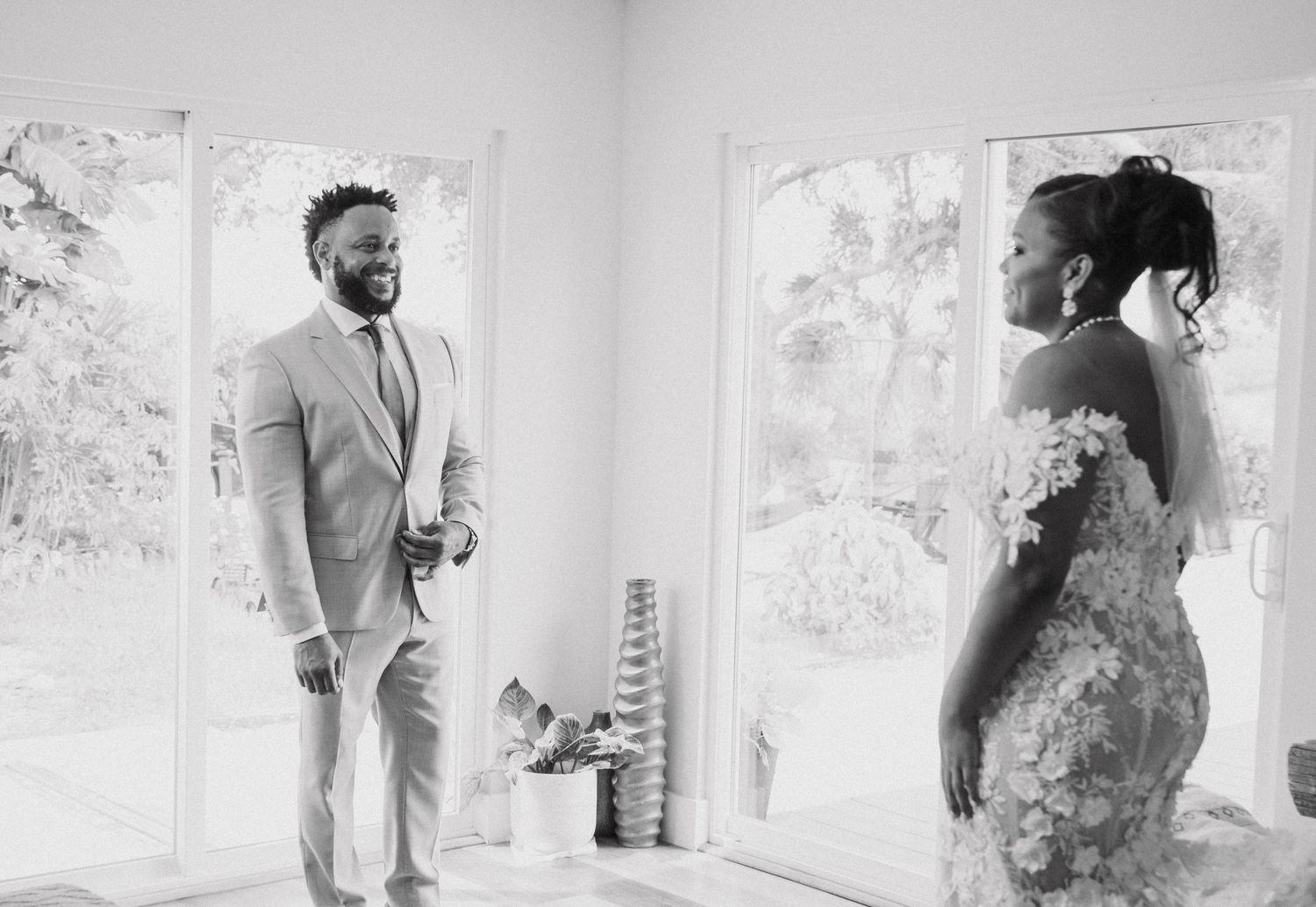 Black and white photo series showing candid moments between a couple in a bright interior space.