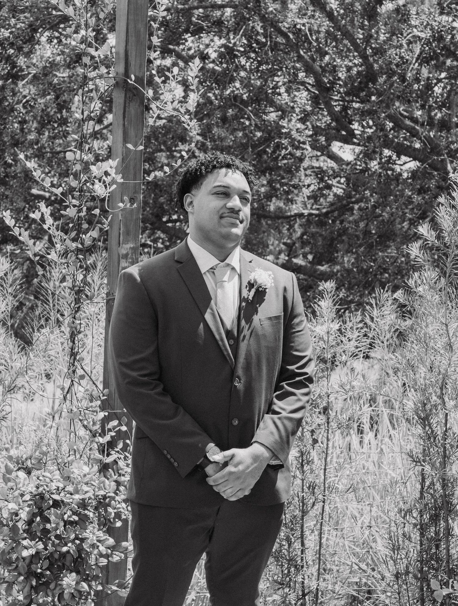Series of black and white outdoor portraits showing two people in formal attire standing among trees.