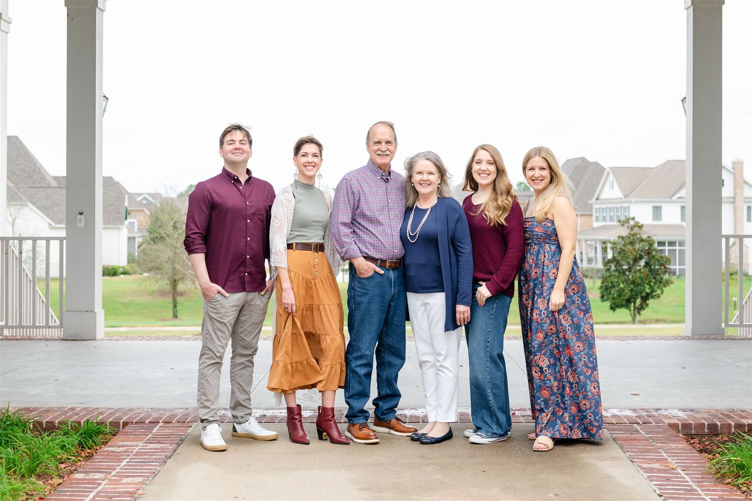 A group of family standing together on a porch in Conroe, Texas.