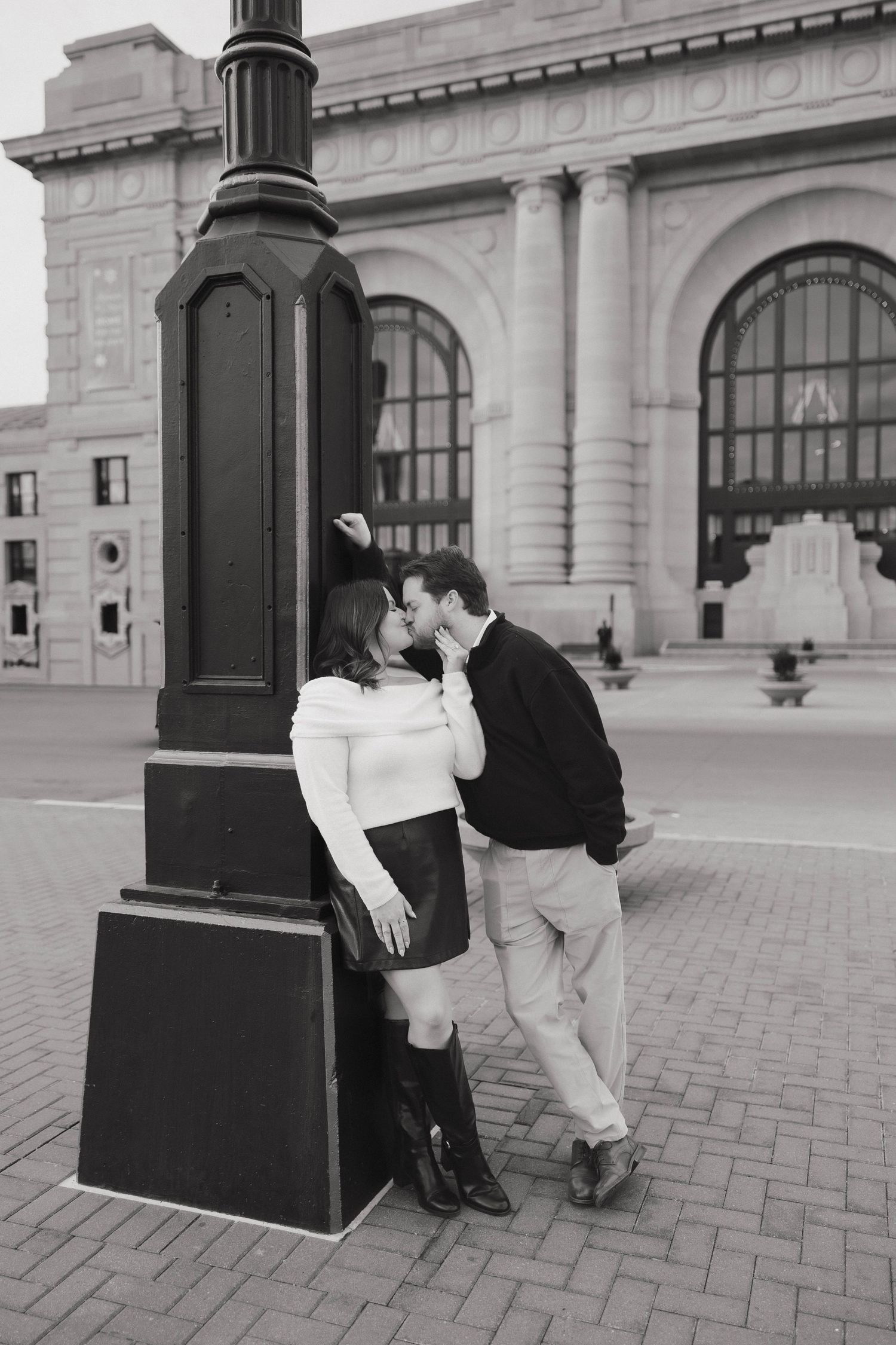 A sequence of black and white photos showing a romantic moment on a bench near classical architecture.