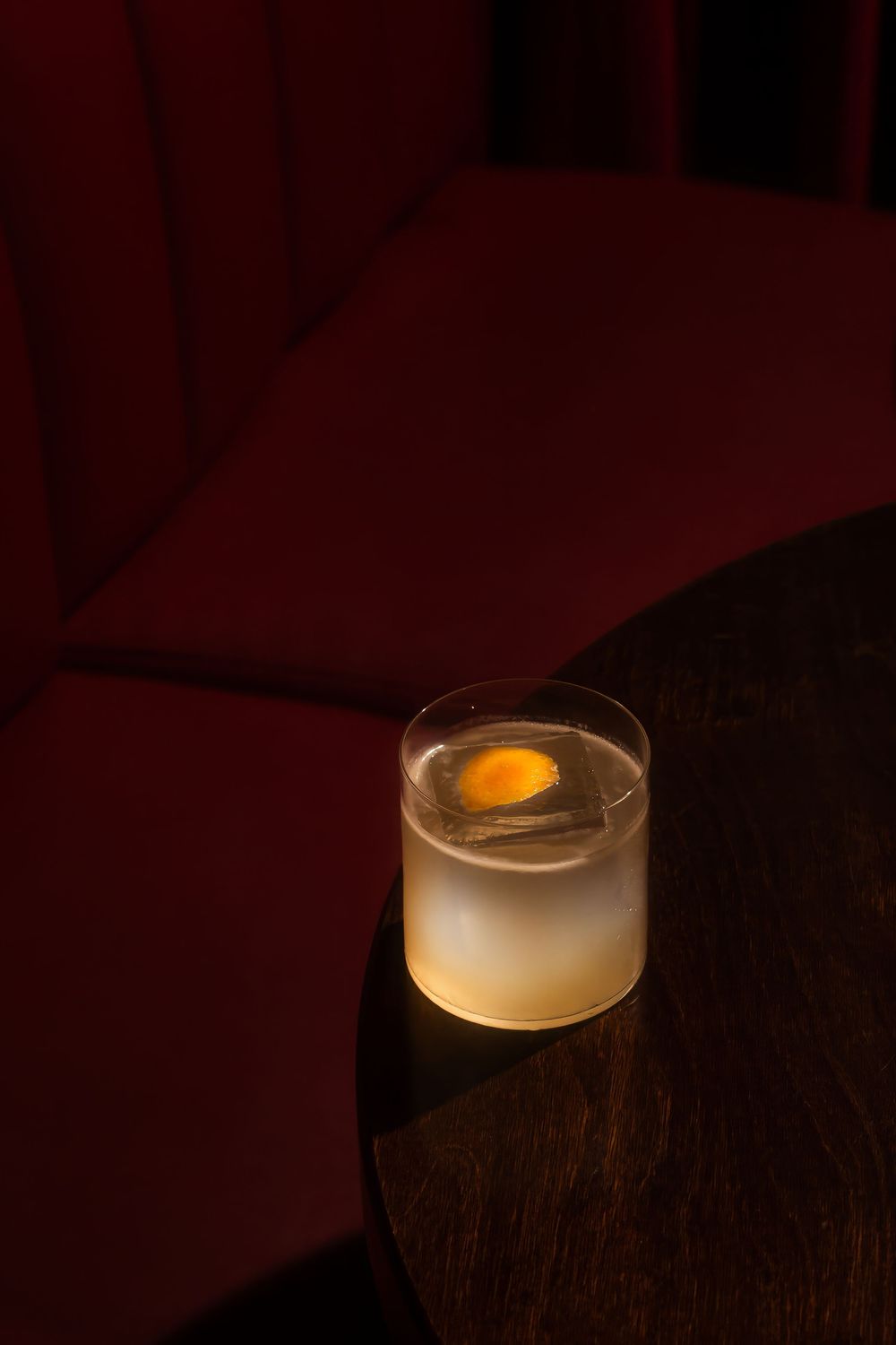A glowing white orb or light fixture casts a warm ambient glow in a dark room setting.