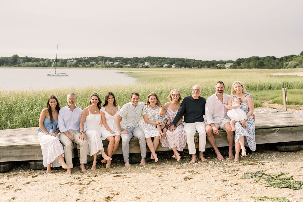 A series of family photos showing people sitting together on a wooden dock by the water at sunset.