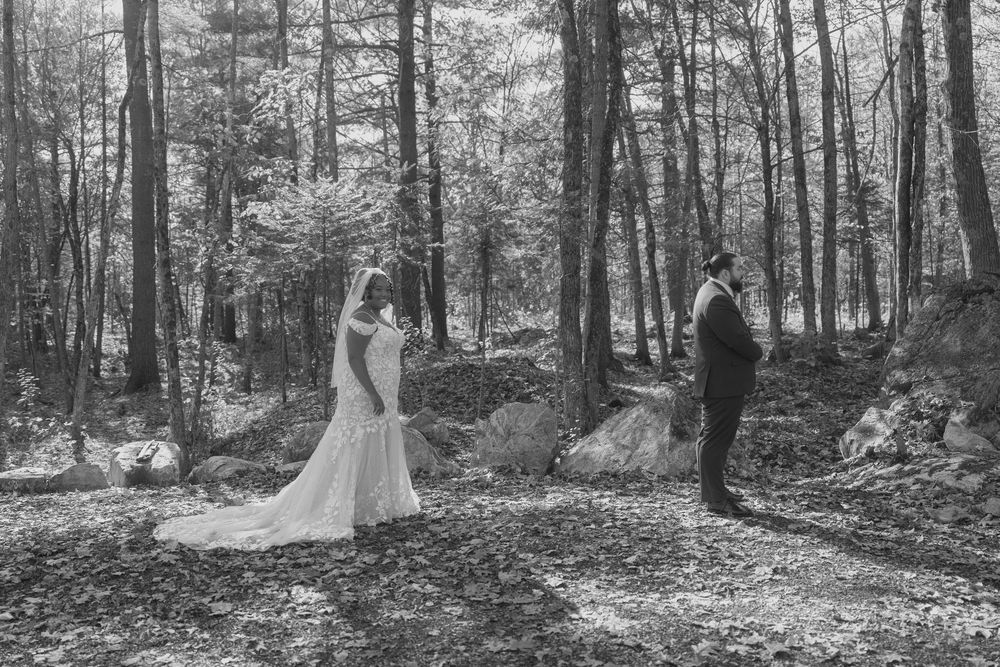 A series of black and white forest wedding photos showing a bride in a flowing gown among tall trees.