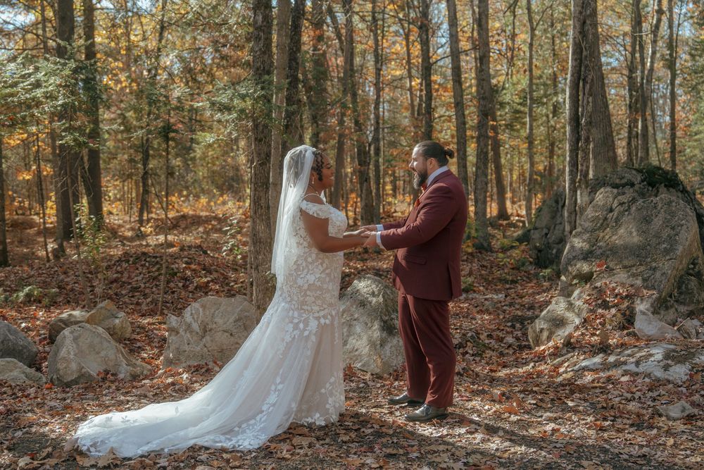A couple shares an intimate moment during their fall wedding photoshoot in a wooded setting.