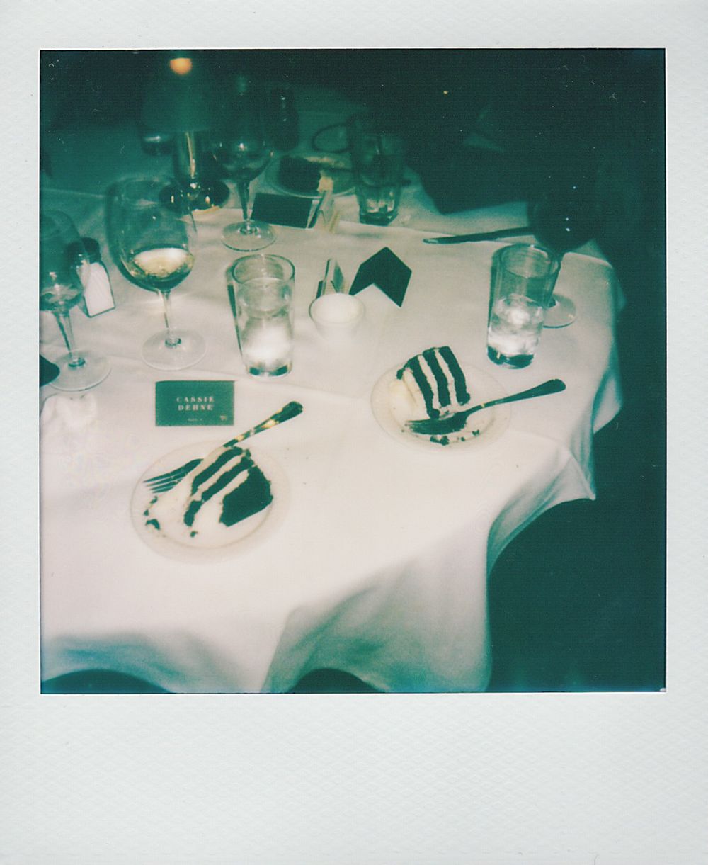 Formal dining table settings with white tablecloths, glassware, and place settings in a teal-tinted lighting atmosphere.