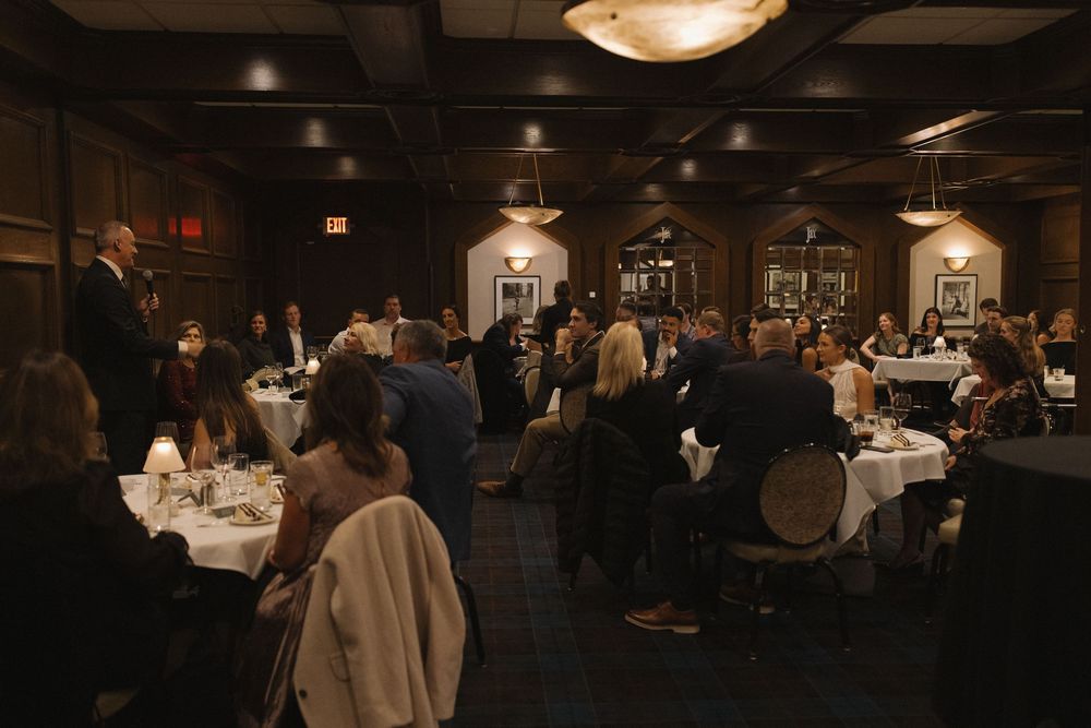 Dark and moody restaurant interior with tables and ambient lighting creating an intimate atmosphere.