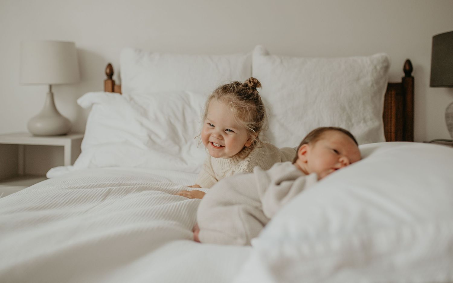 A series of five connected photos showing children sleeping peacefully in white bedding at different angles.