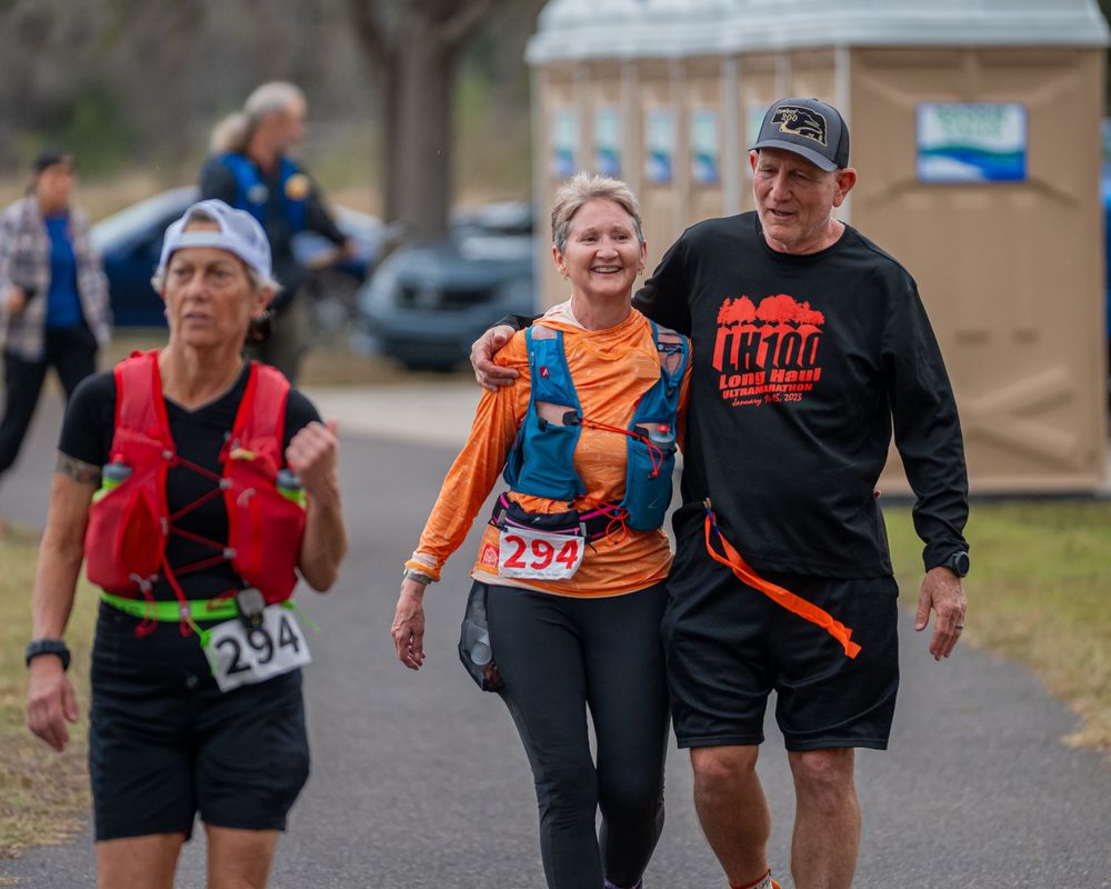 Participants walking together during an outdoor running event on a paved path.