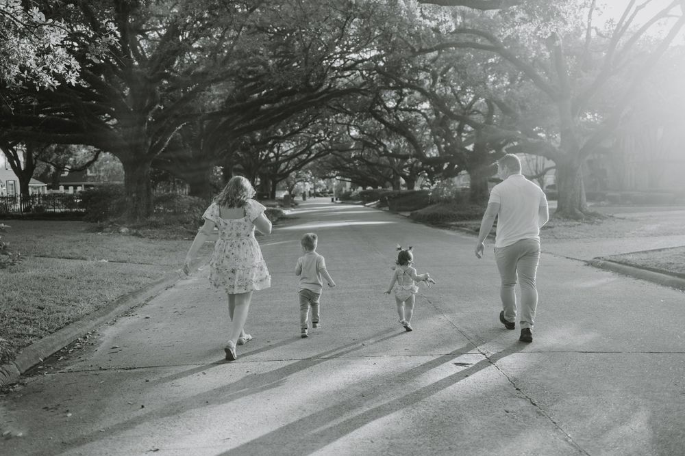 Black and white series of a family walking away on a winding path together.