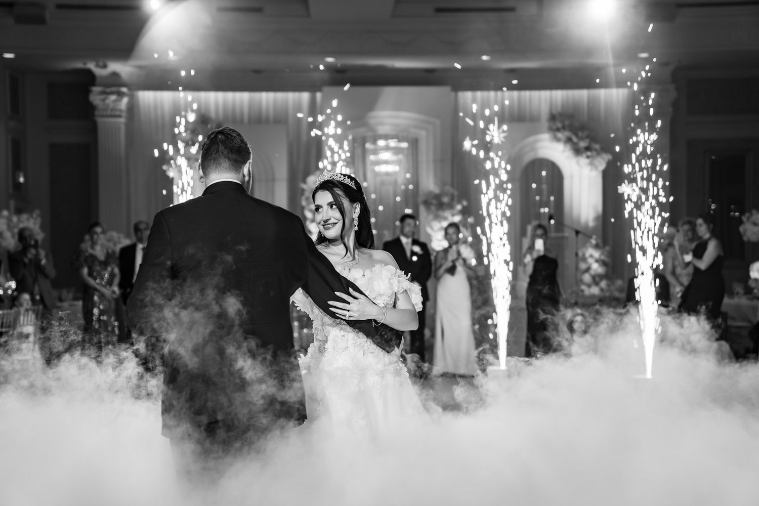Bride and groom share first dance surrounded by fireworks and dry ice fog effects at Parkview Manor Banquet Hall.