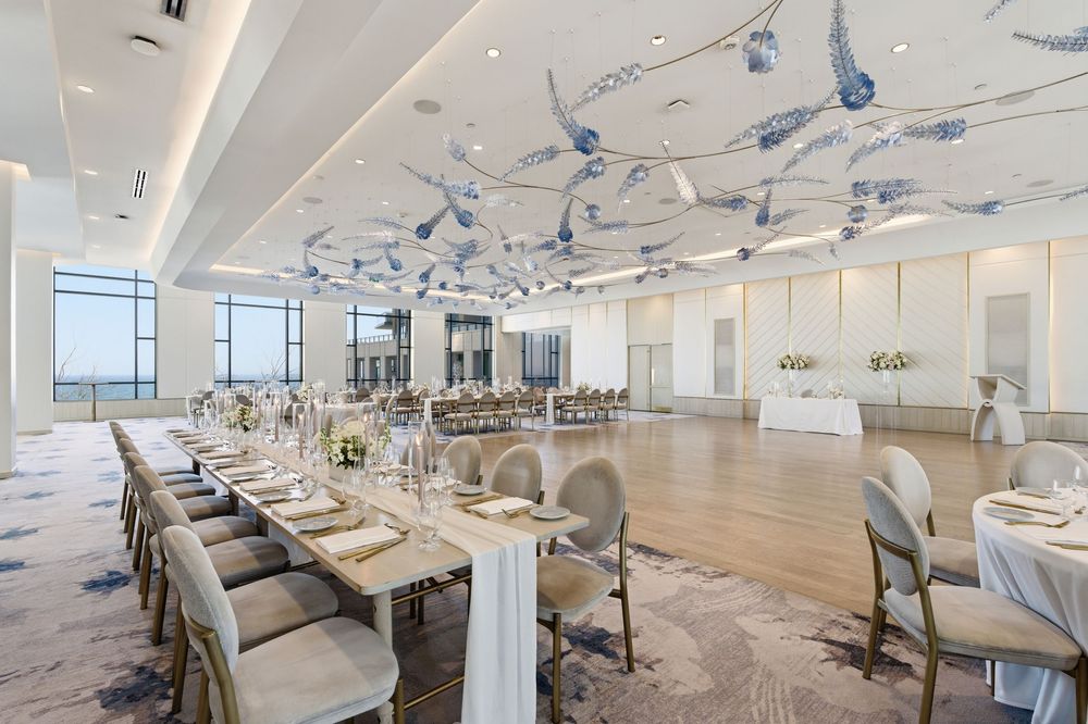 Expansive dining area with modern decor featuring blue art installations across the ceiling.