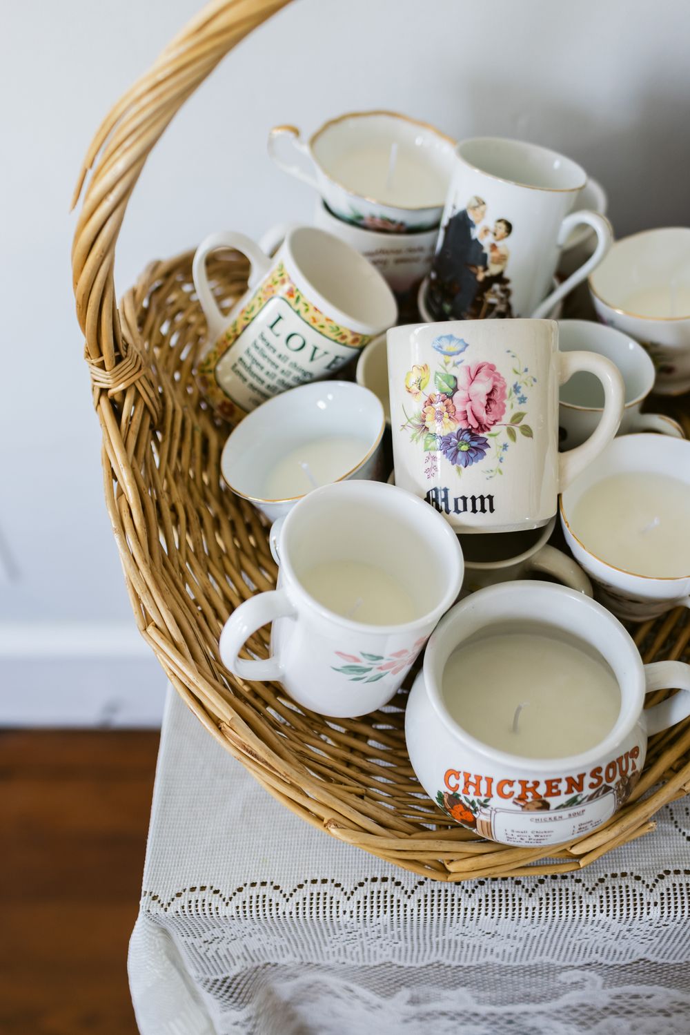 Vintage coffee cups and teacups lay in a basket for wedding guests gifts in a home in Warren, Rhode Island. Newport wedding photographer