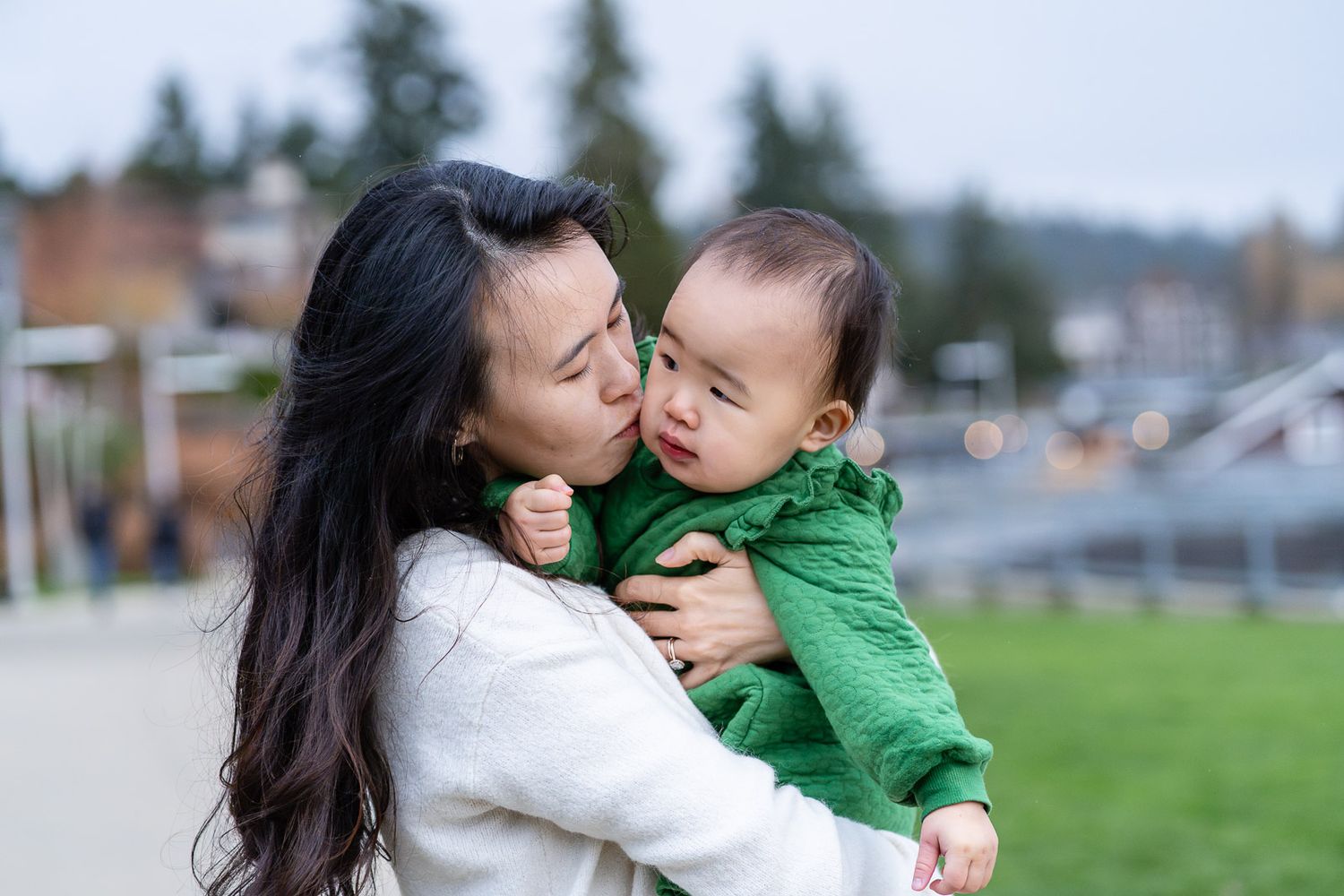 Mom kissing baby