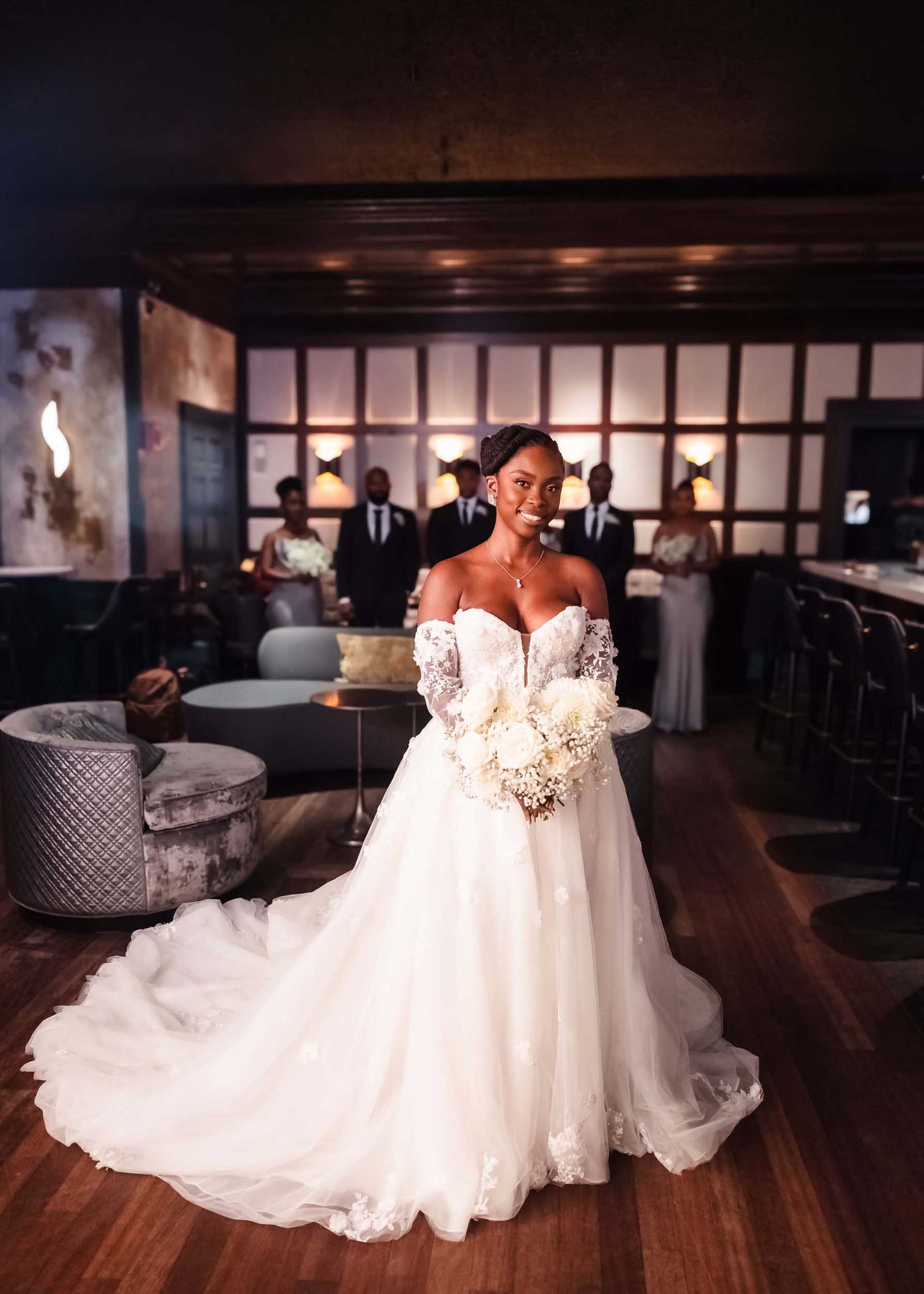 Bride walking into first look in The Irving tavern at Lenox Hotel Boston with wedding party in background
