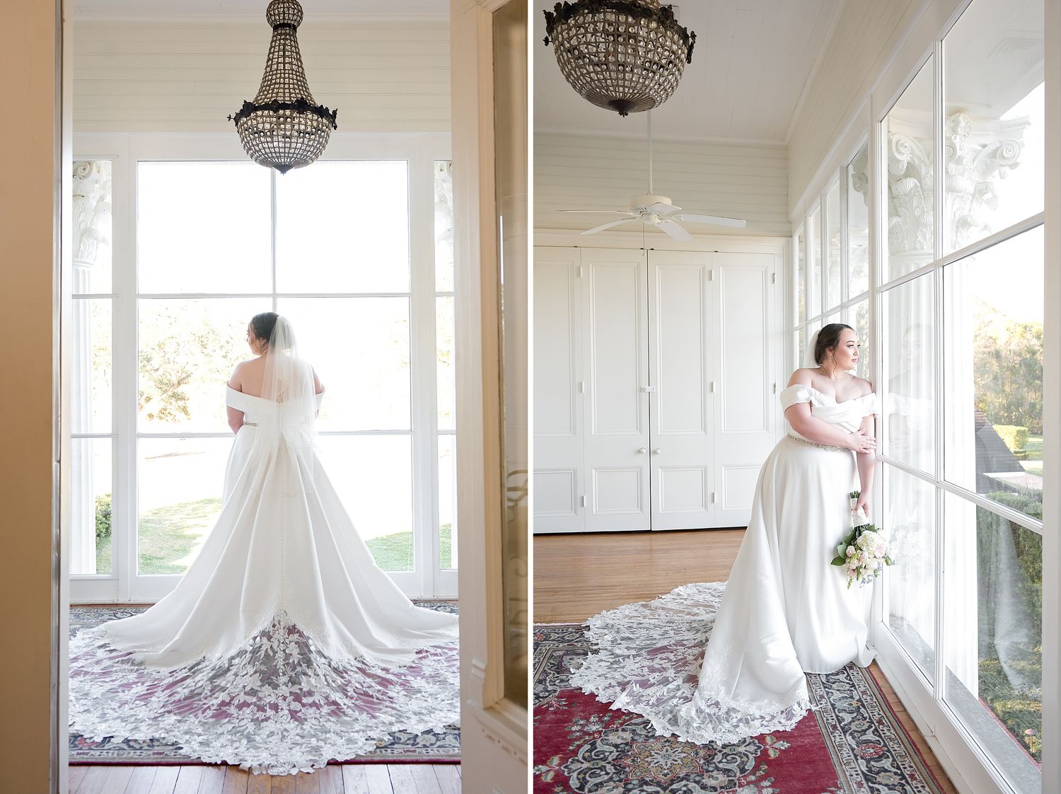 Bride in elegant white gown with lace train stands by large windows in a sunlit room with chandelier.