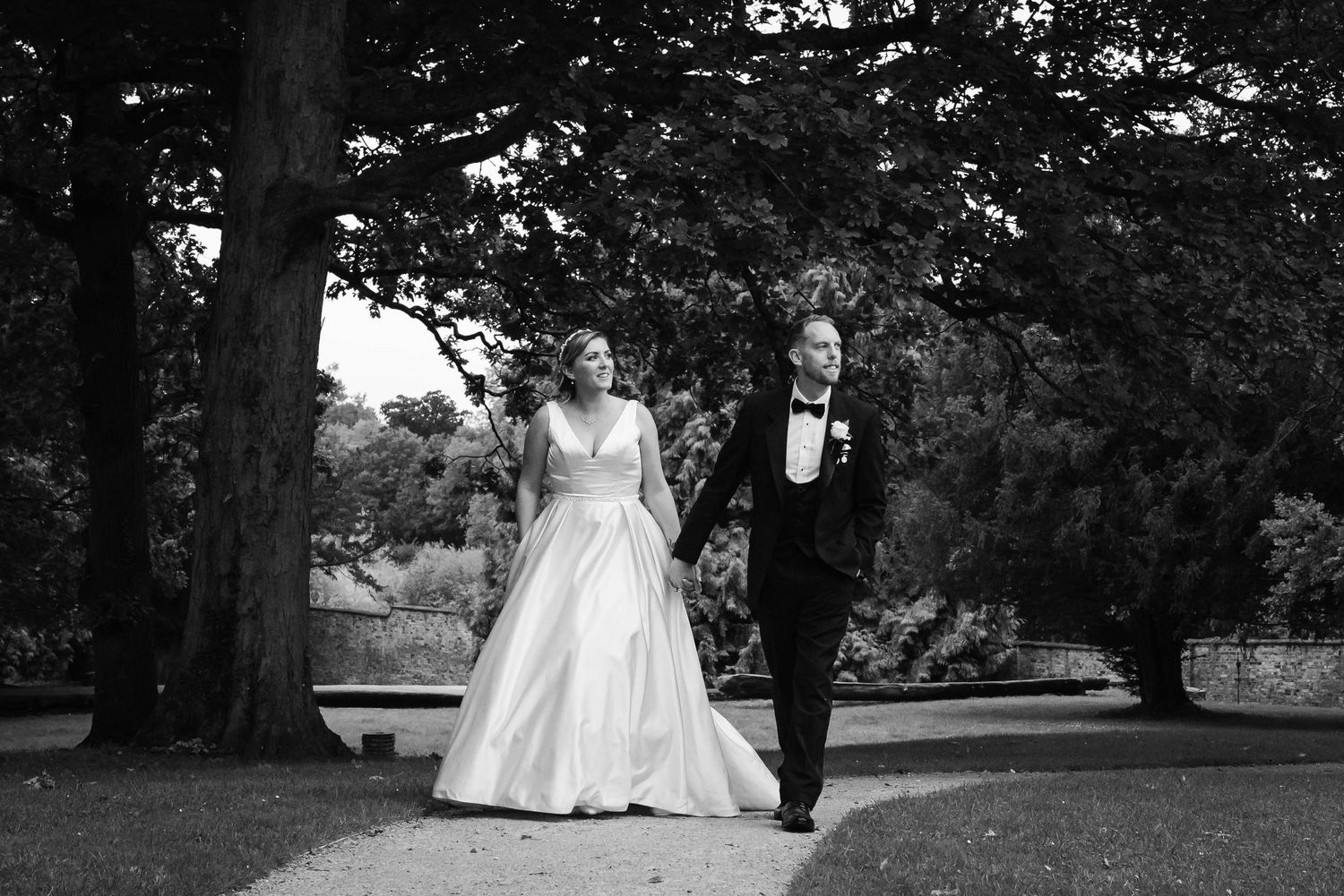 Cotswolds Wedding Photographer Zara Davis Photography Gloucestershire Eastington Park couple walking in teh garden