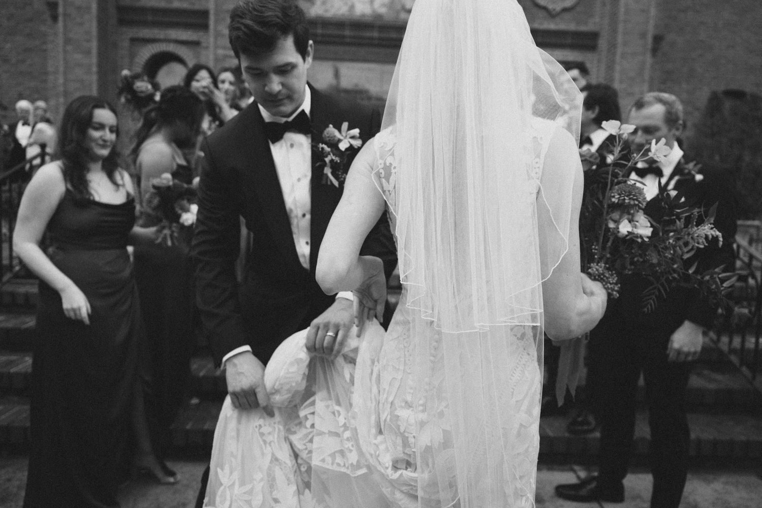 Black and white wedding photo capturing romantic moment between newlyweds.