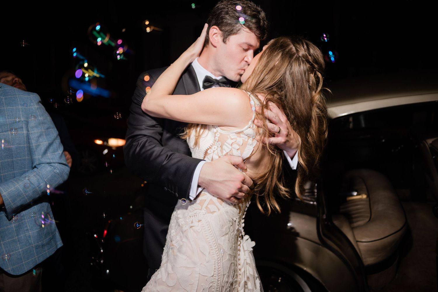 Romantic couple sharing their first kiss as newlyweds during an intimate wedding celebration.