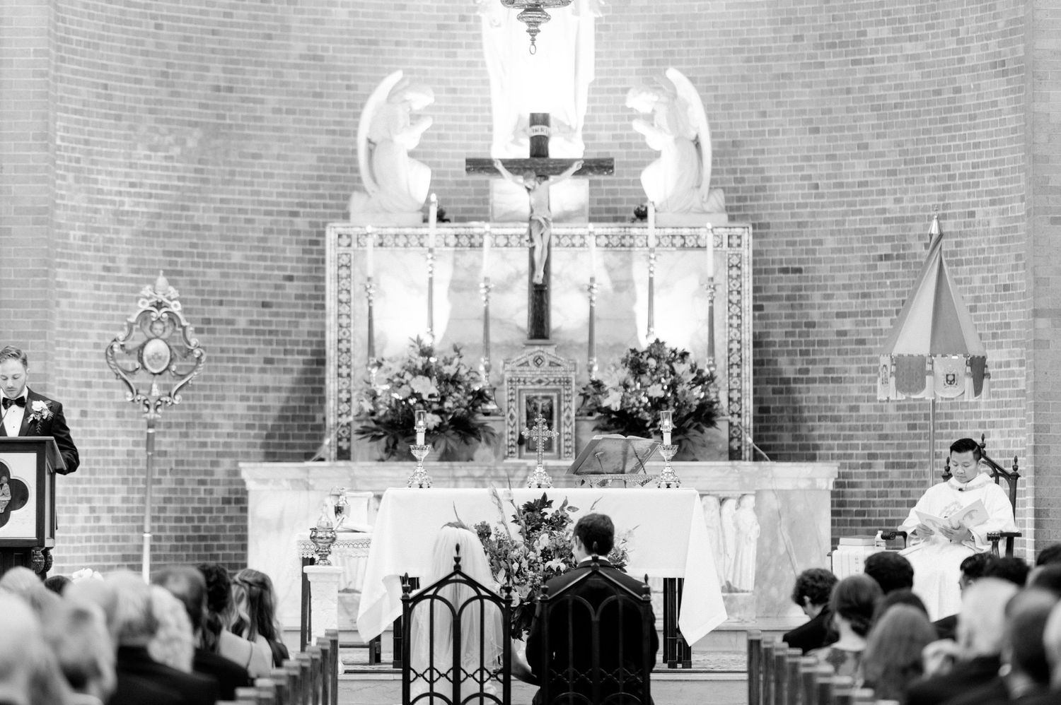 Traditional church interior with altar and cross decorations during a wedding ceremony.