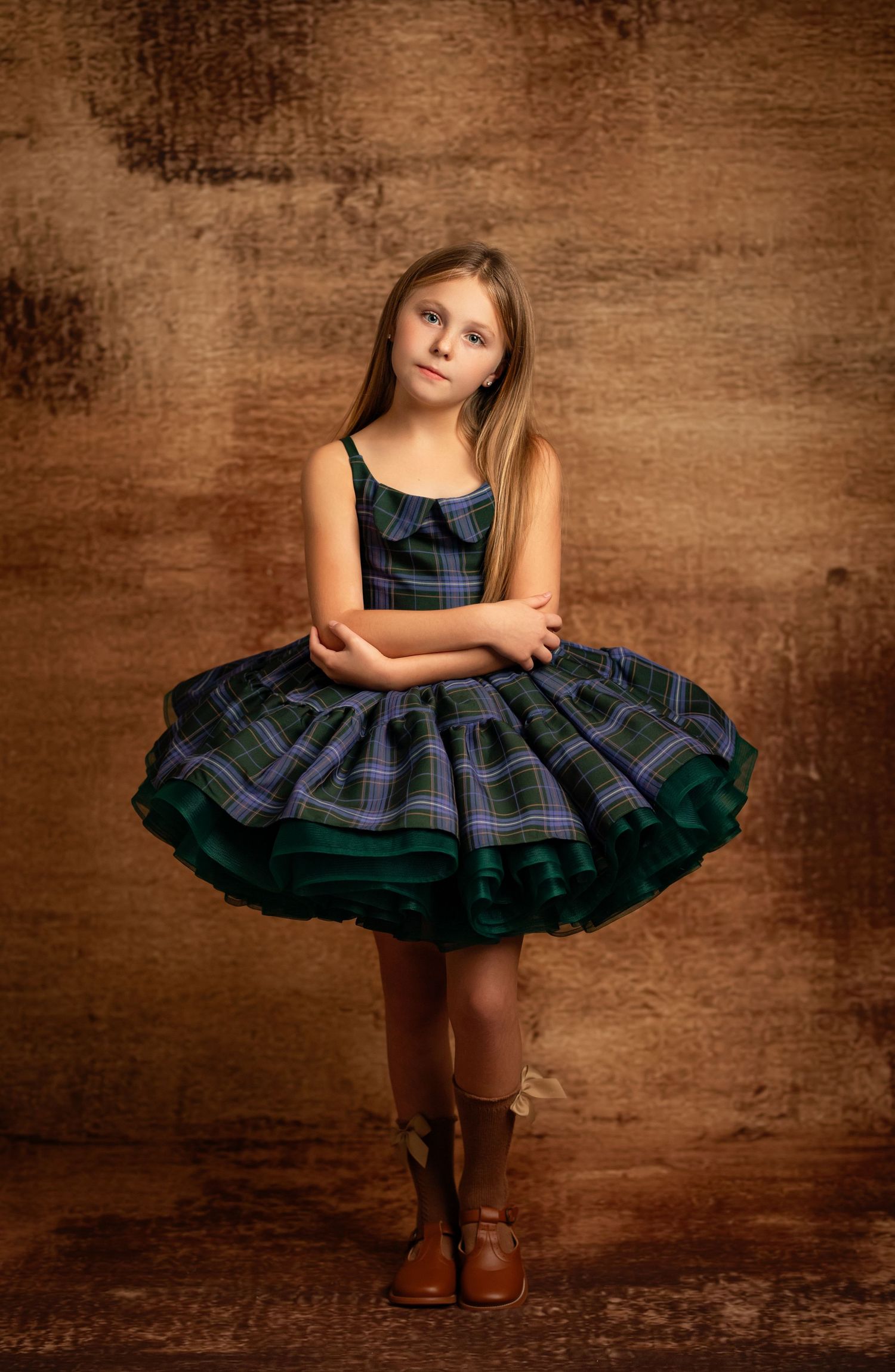 Playful portrait in a sparkly plum-colored party dress against a purple background.