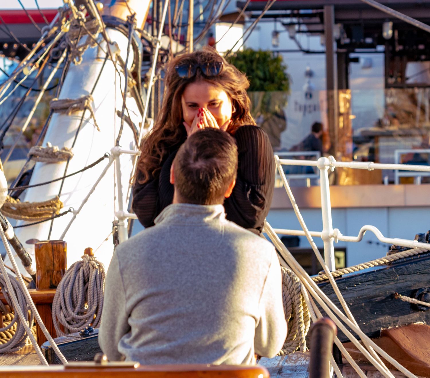 Couple sharing a romantic moment on a vintage tall ship photographed by Zeus Holbrook Wedding Photographer in San Diego