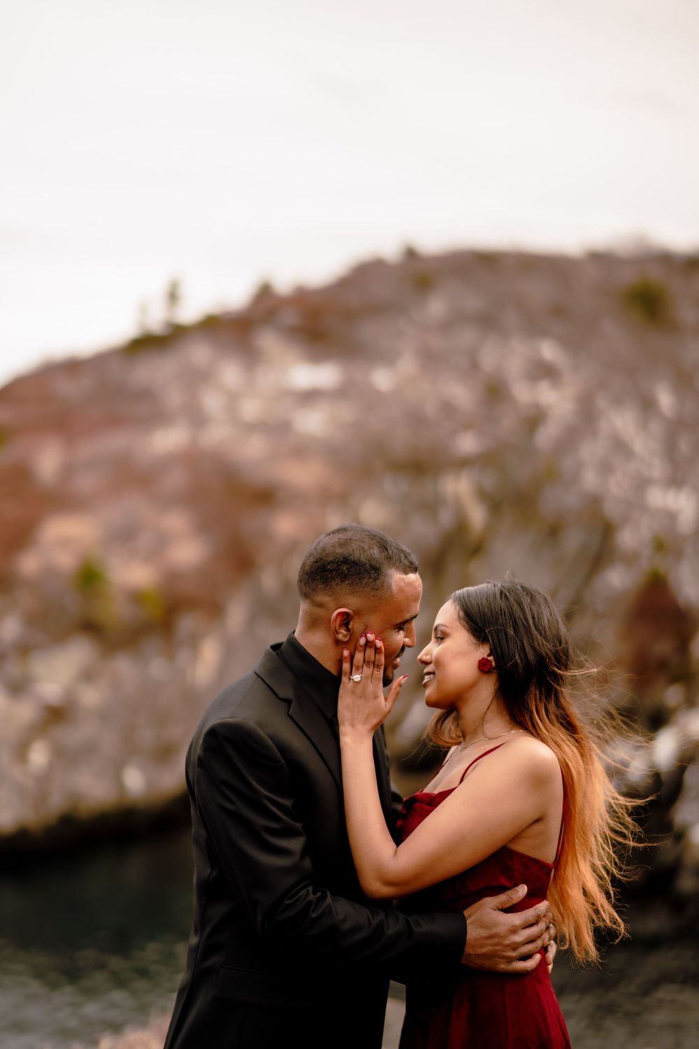 couple kissing on cliffside during engagement session, Quidi Vidi Newfoundland