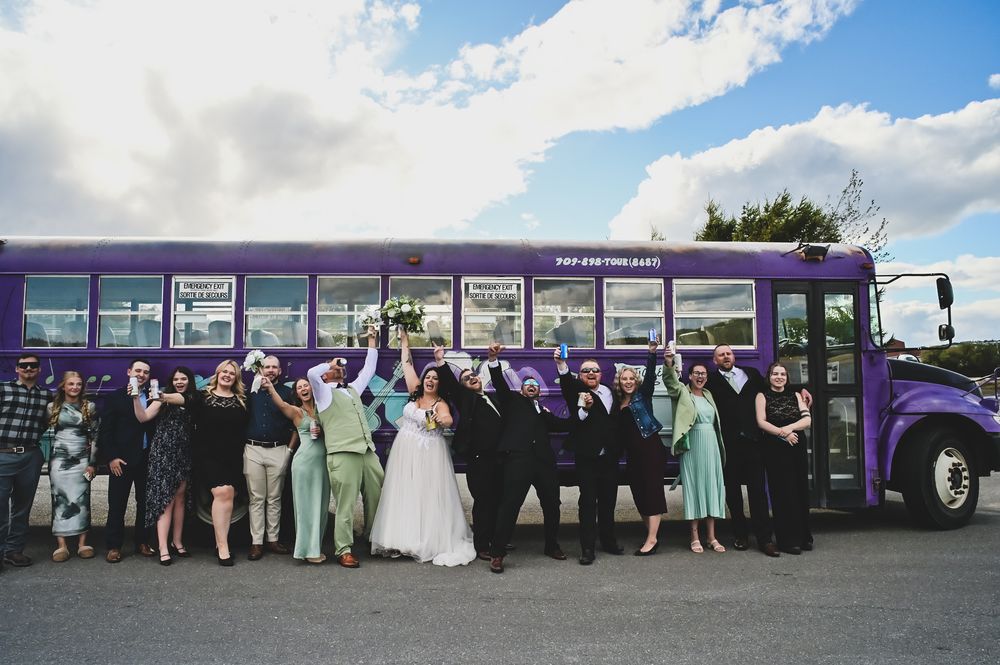 wedding party lined up in front of party bus, bride groom and bridal party Newfoundland wedding