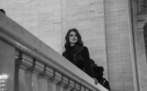 Black and white portrait of elegant woman on balcony at Grand Central Terminal NYC.