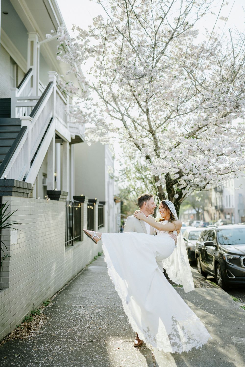 Artistic wedding photography sequence showing couple dancing under blooming spring trees.