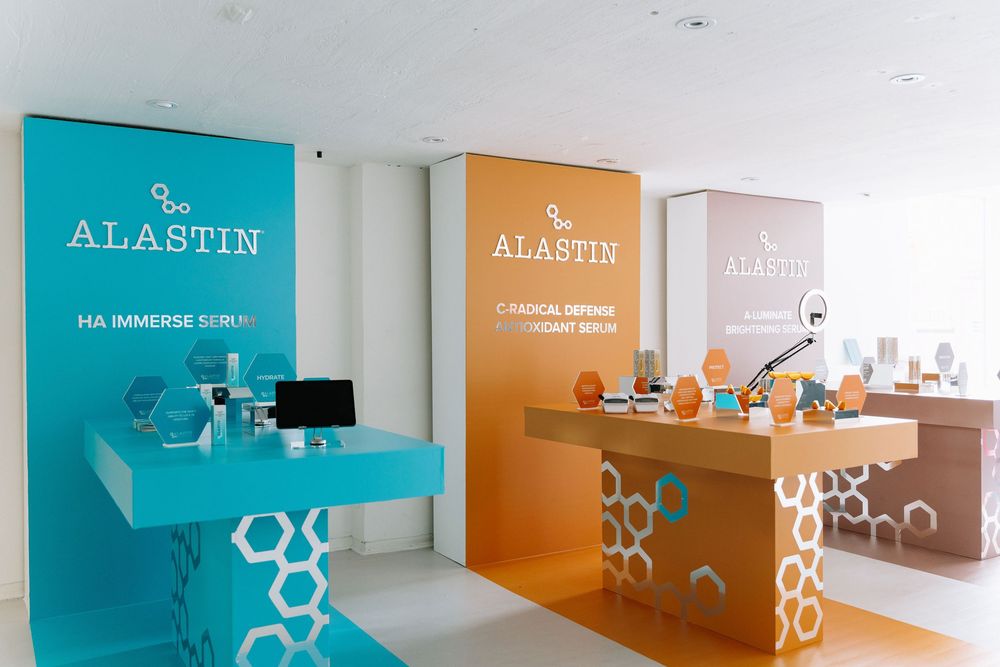Modern office interior with teal and orange accent walls featuring minimalist shelving and geometric wall decorations.