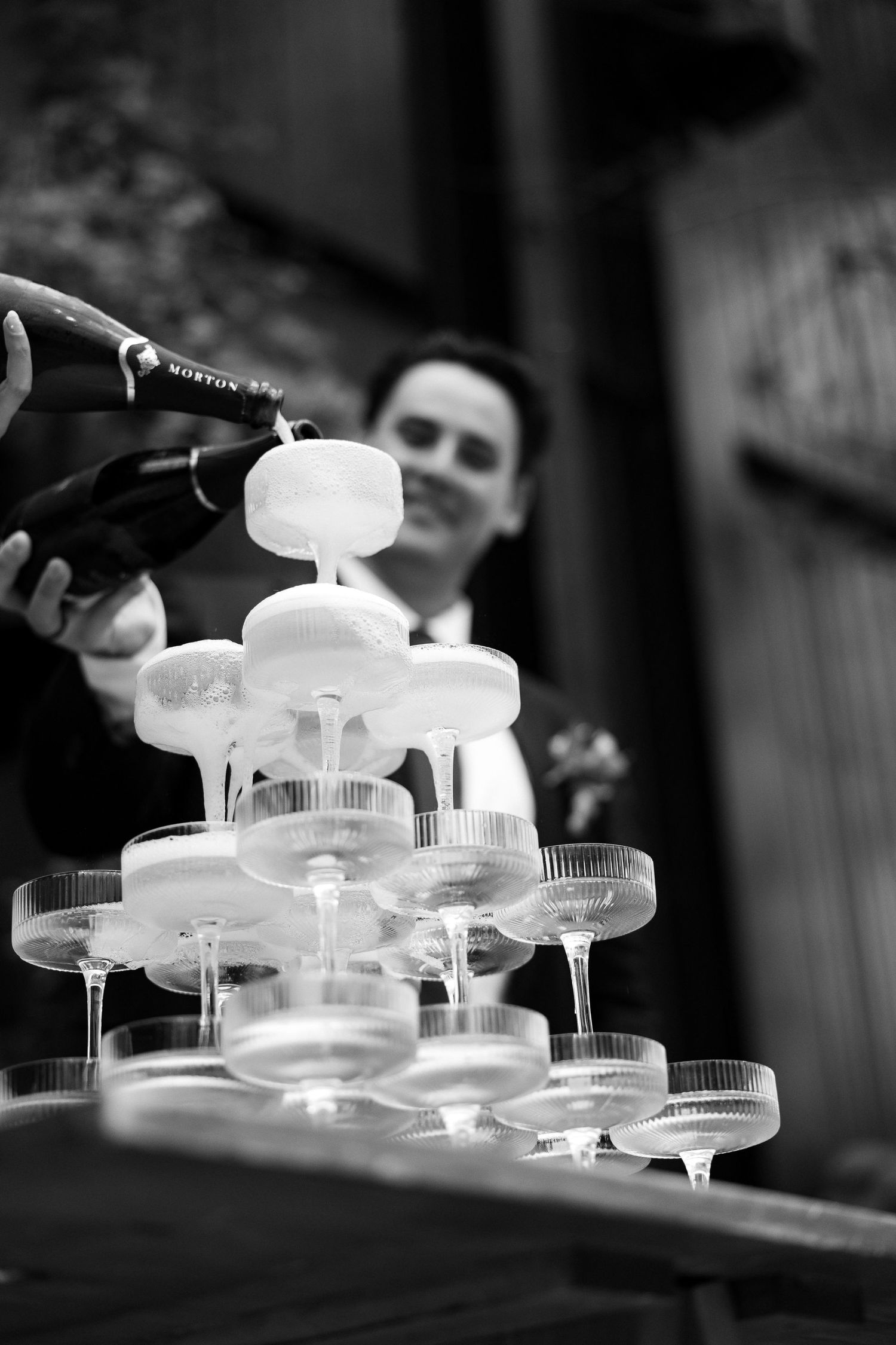 Black and white series of champagne glasses arranged in artistic patterns. Auckland Wedding Photographer and videographer