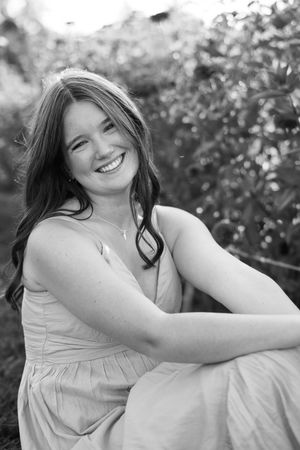 A series of black and white portraits showing joyful expressions in a natural outdoor setting.