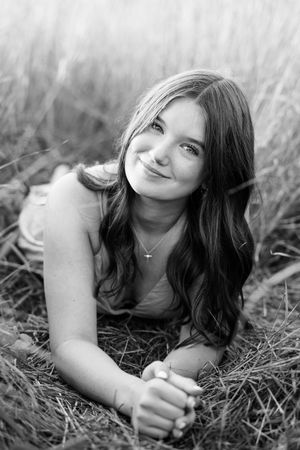 Black and white portraits captured while lying in natural grass.