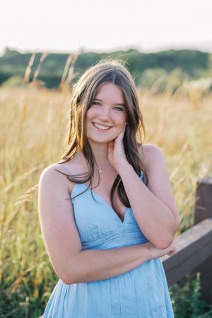 Natural outdoor portraits featuring a light blue dress against golden grass.