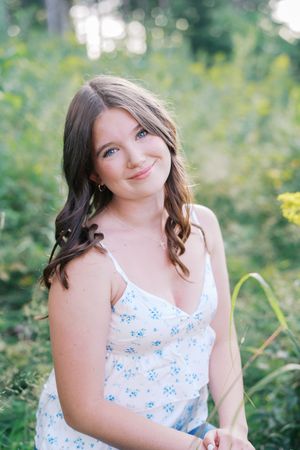 Close-up outdoor portrait with natural lighting and soft bokeh effect in background.