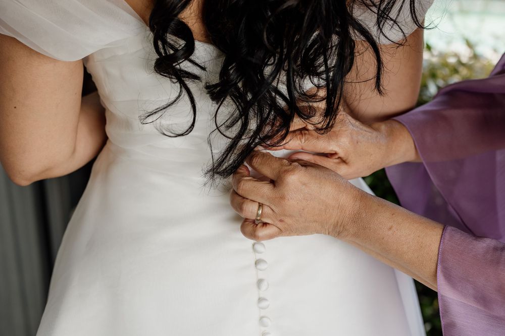 A bride and groom share an intimate embrace during their wedding ceremony, with soft lighting and romantic ambiance.
