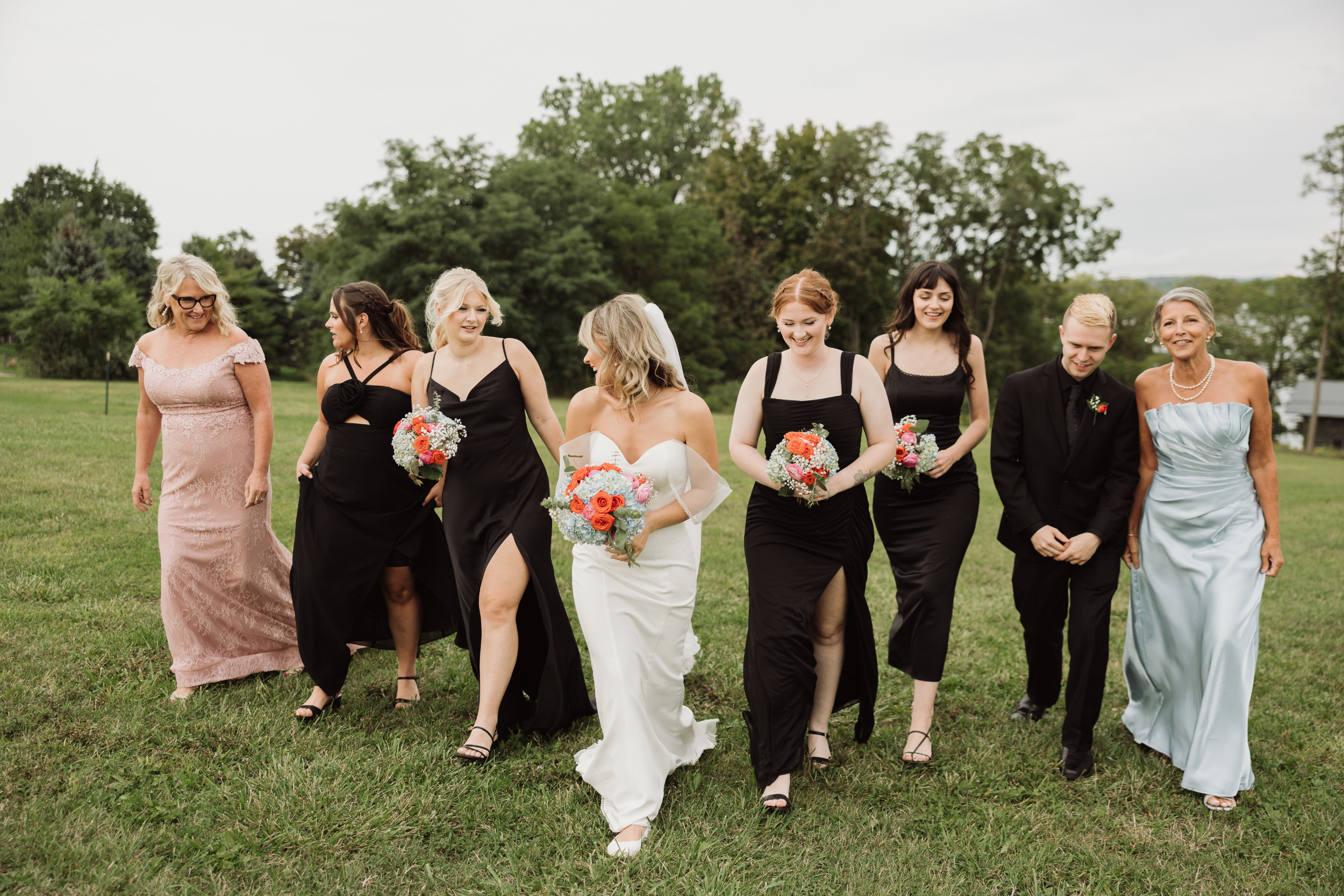 Bridal party celebrating with bride and groom during Finger Lakes wedding