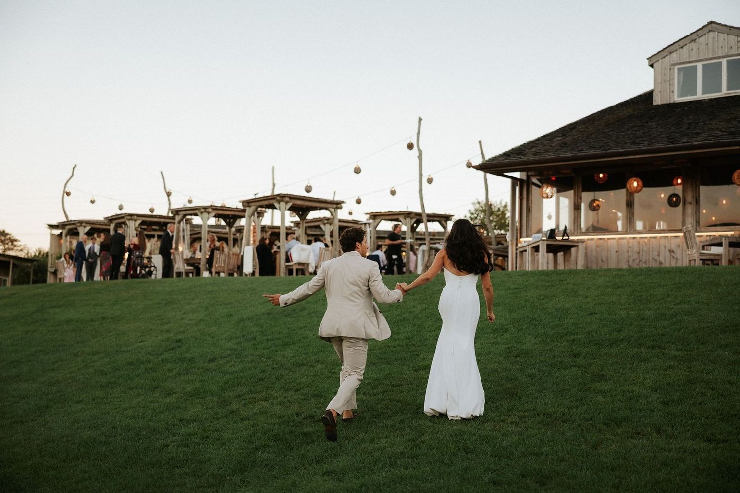 Bride and groom walking to cocktail hour at The Crow's Nest